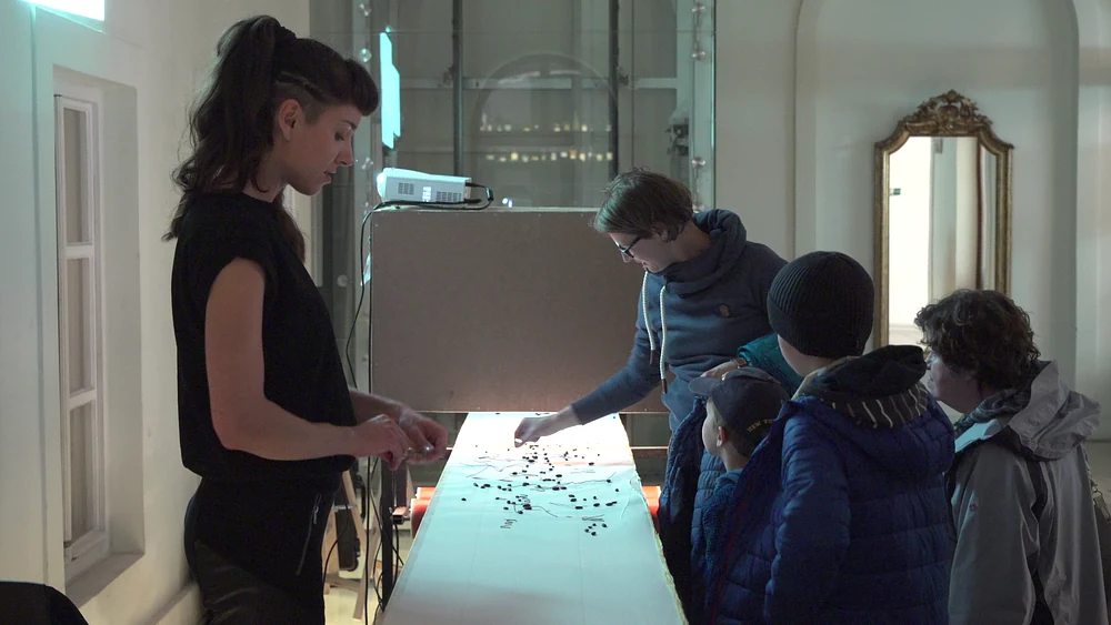Zuzana Sabová and visitors playing Grafofon at the Slovak National Gallery; photograph by Juraj Starovecký