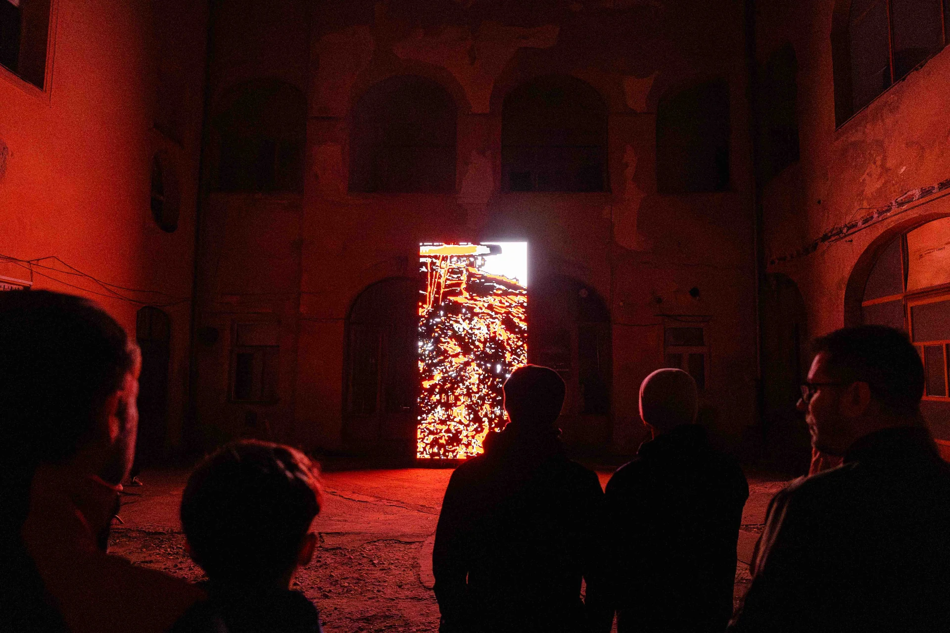 Audience silhouettes in front of the illuminated installation